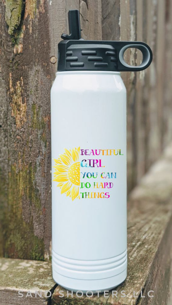 Photo of a white 32 oz water bottle with color printed image of a sunflower and text that reads "Beautiful girl, you can do hard things."